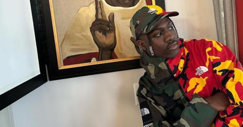 Lil Yachty has his arms crossed while wearing Northface x Supreme Collaboration