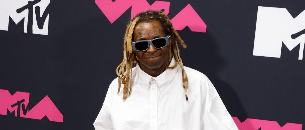 Lil Wayne poses in the press room at the 2023 MTV Video Music Awards wearing glasses and white shirt