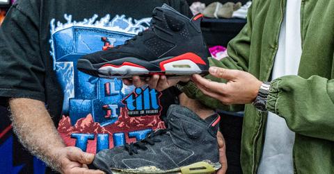 Store owner Joshua Solis, right, holds a re-release of the vintage Jordan