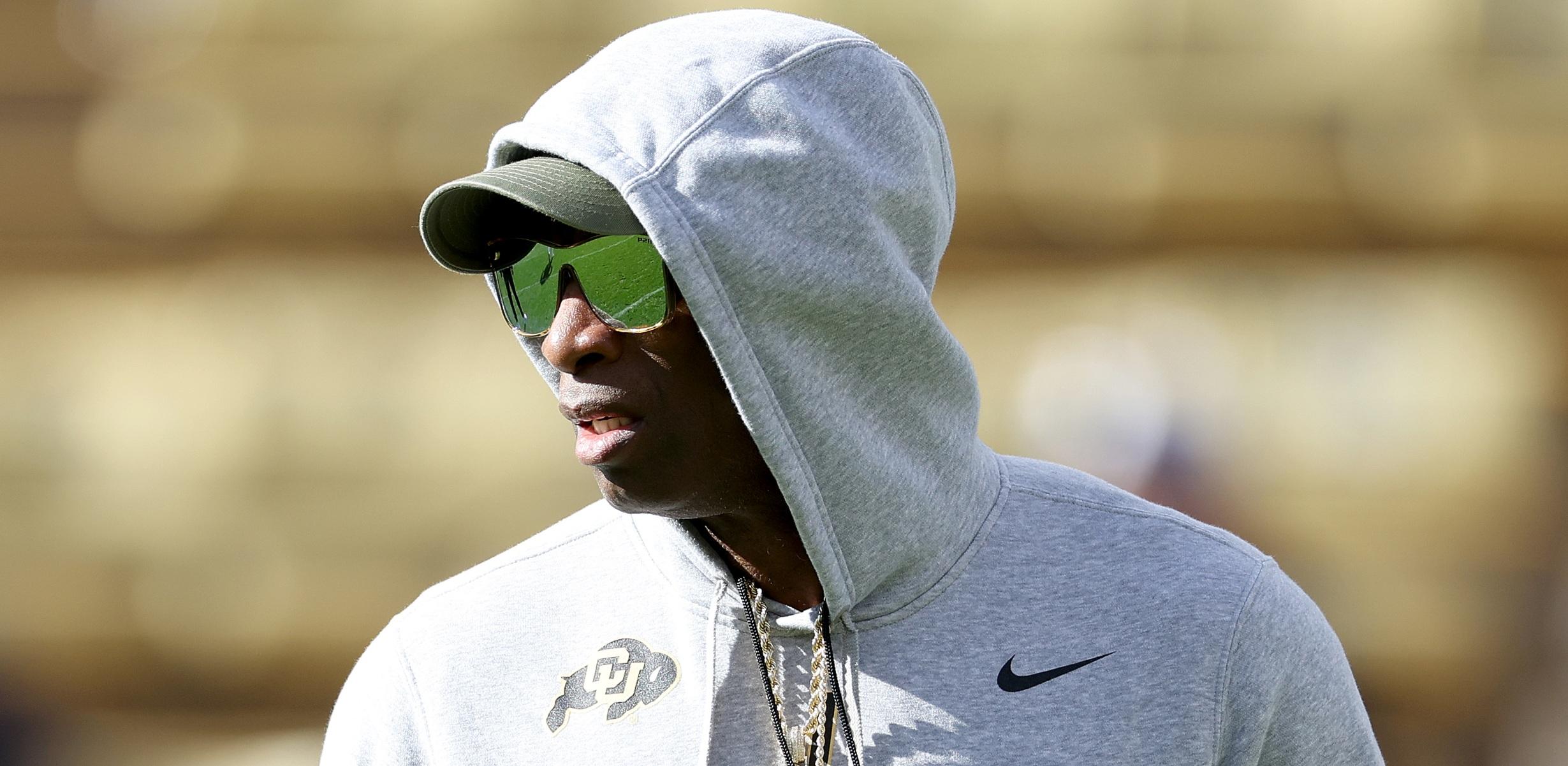 head coach deion sanders of the colorado buffaloes watches as his team warms up