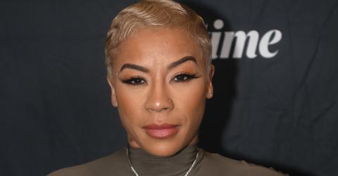 Keyshia Cole is looking into the camera.