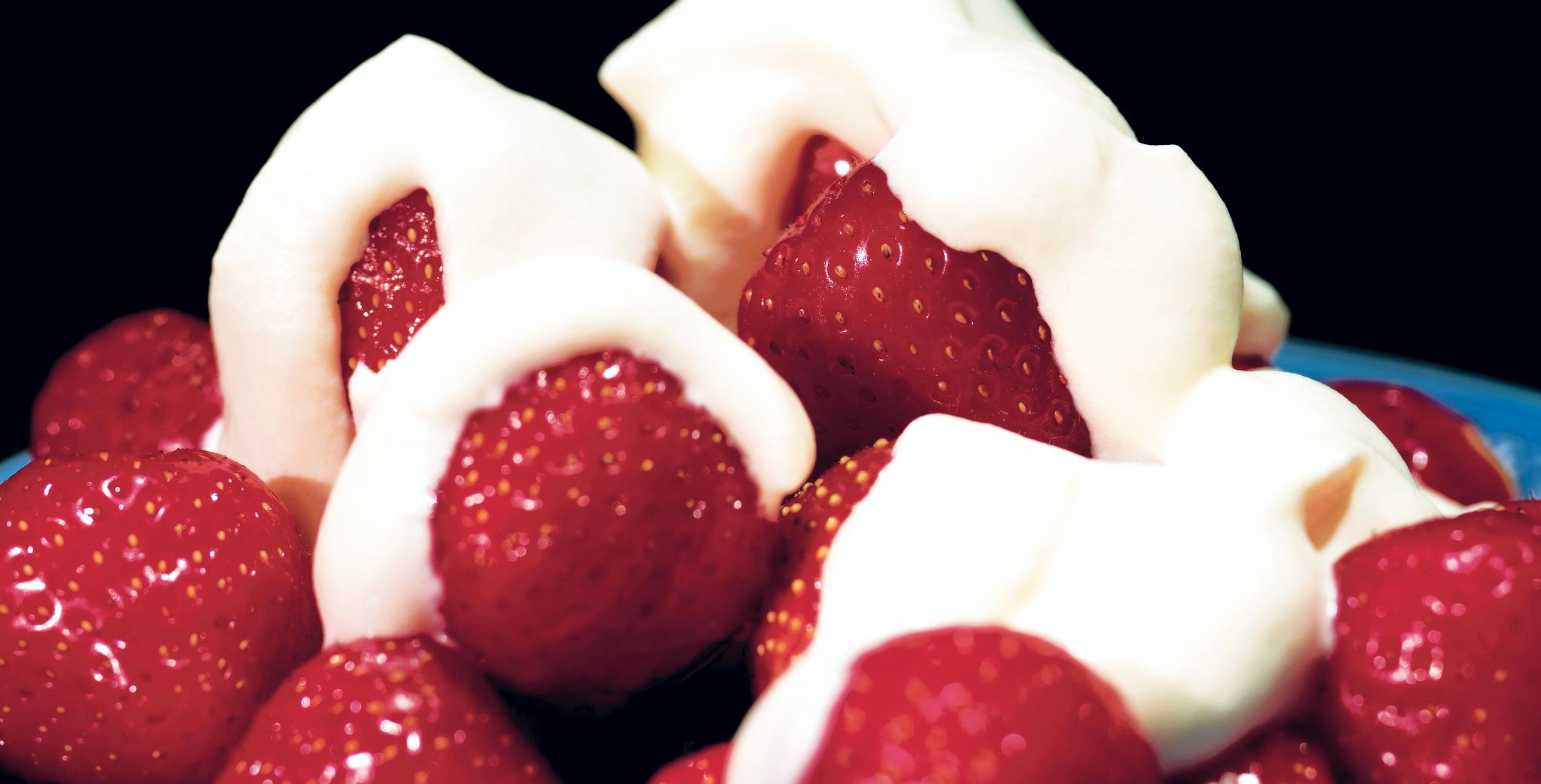 close up of a bowl of strawberries and yogurt