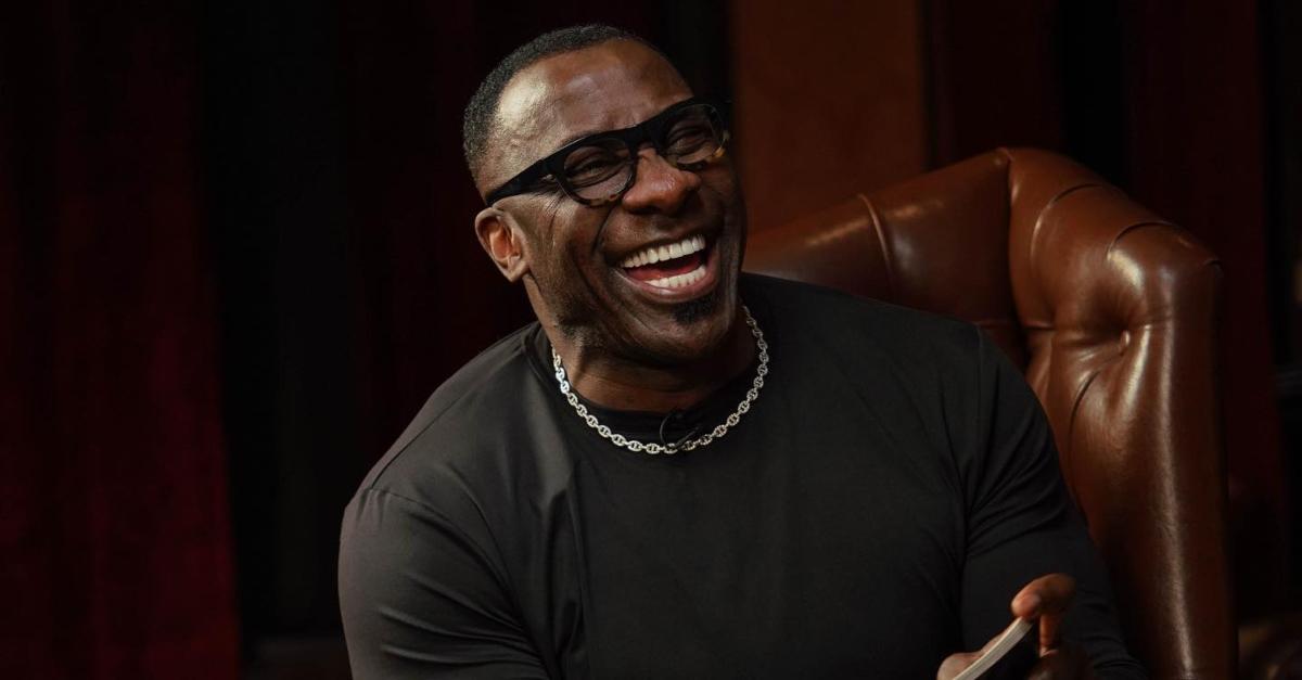 Shannon Sharpe wears a black shirt and laughs on 'Club Shay Shay.'