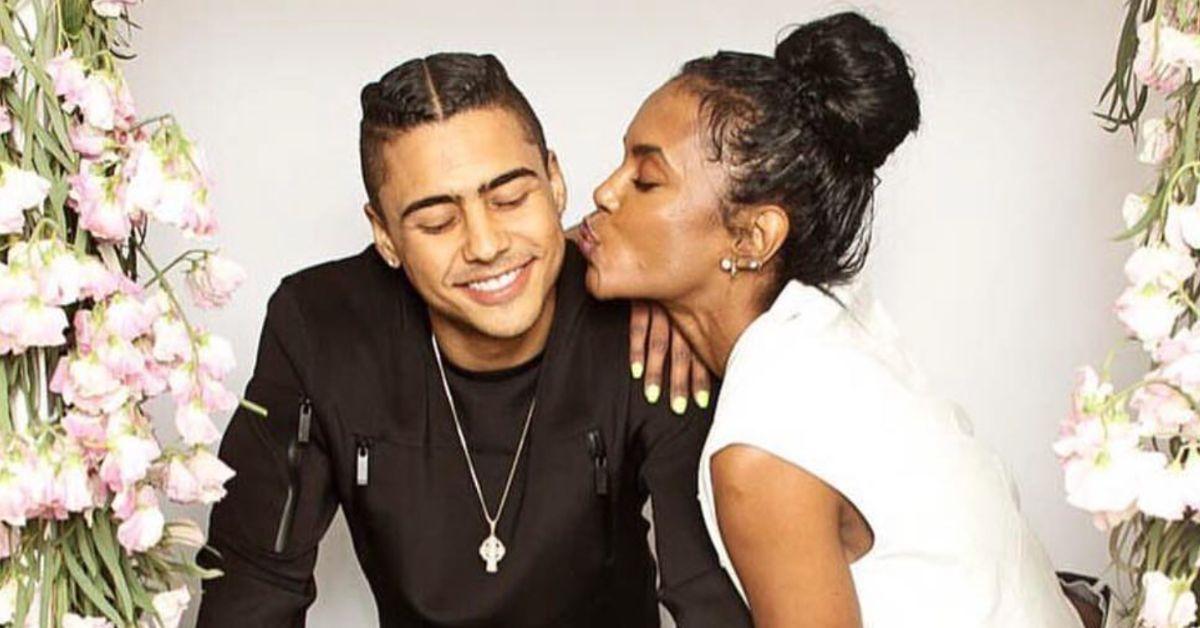 Quincy Brown poses for a photo with mom Kim Porter, who is giving him a kiss on the cheek