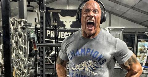 The Rock working out wearing headphones