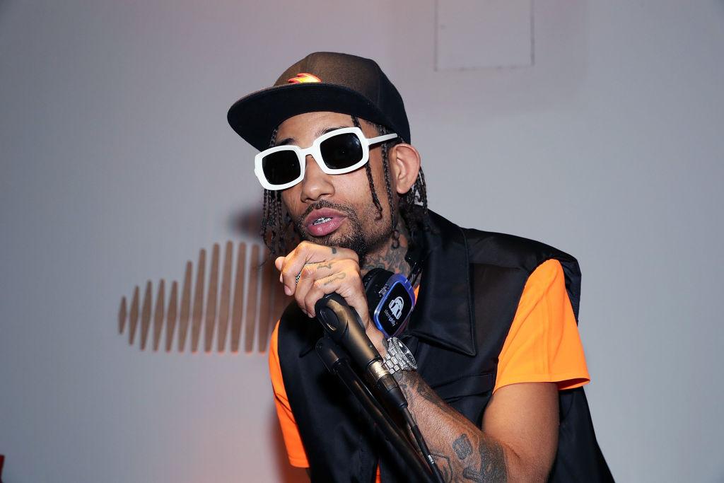 PNB Rock performs at SoundCloud Playback wearing white-rimmed glasses.