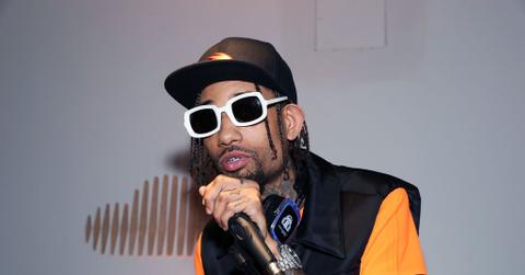 PNB Rock performs at SoundCloud Playback wearing white-rimmed glasses.