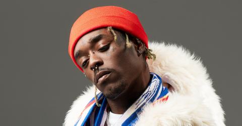 Lil Uzi wears an orange beanie and a fur coat.
