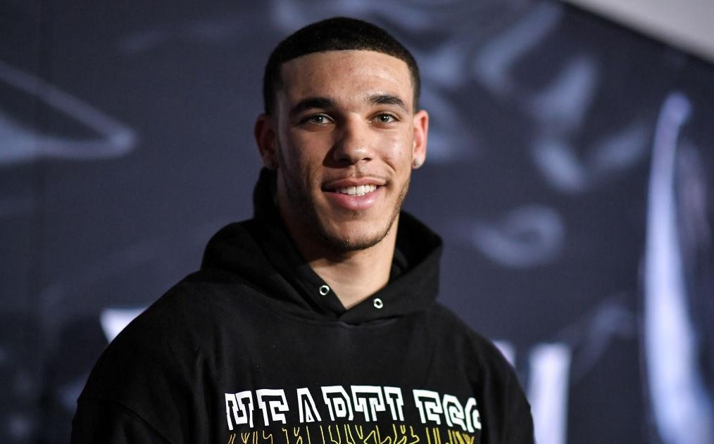 Lonzo Ball smiling and wearing a hoodie that says "Heartless."