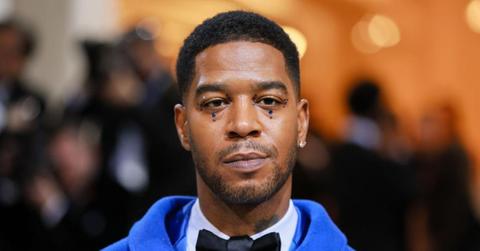Kid Cudi at the 2023 Met Gala wearing blue suit and blue gems.