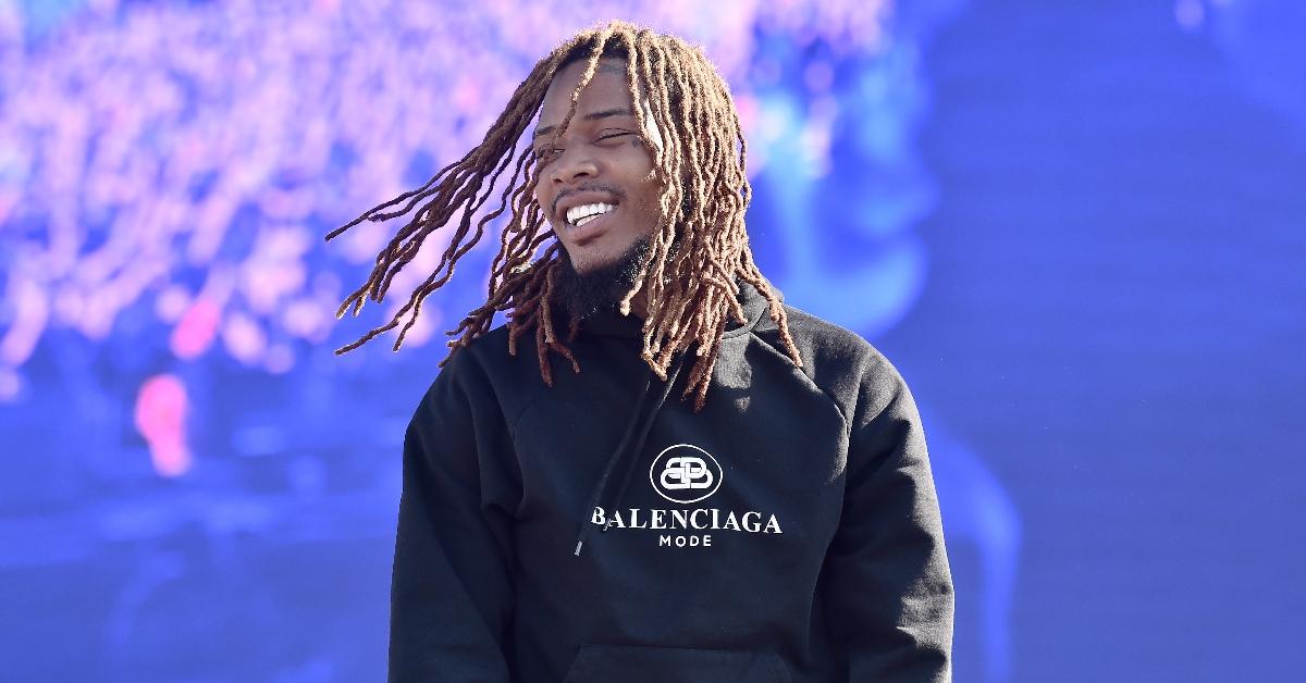 Fetty Wap In black sweat shirt smiling at the crowd.