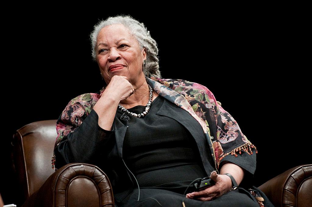 Toni Morrison wears a flore shawl wrap and black linen jacket and dress and attends a panel.