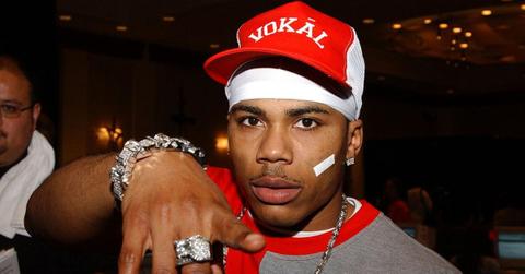 nelly wearing a red hat