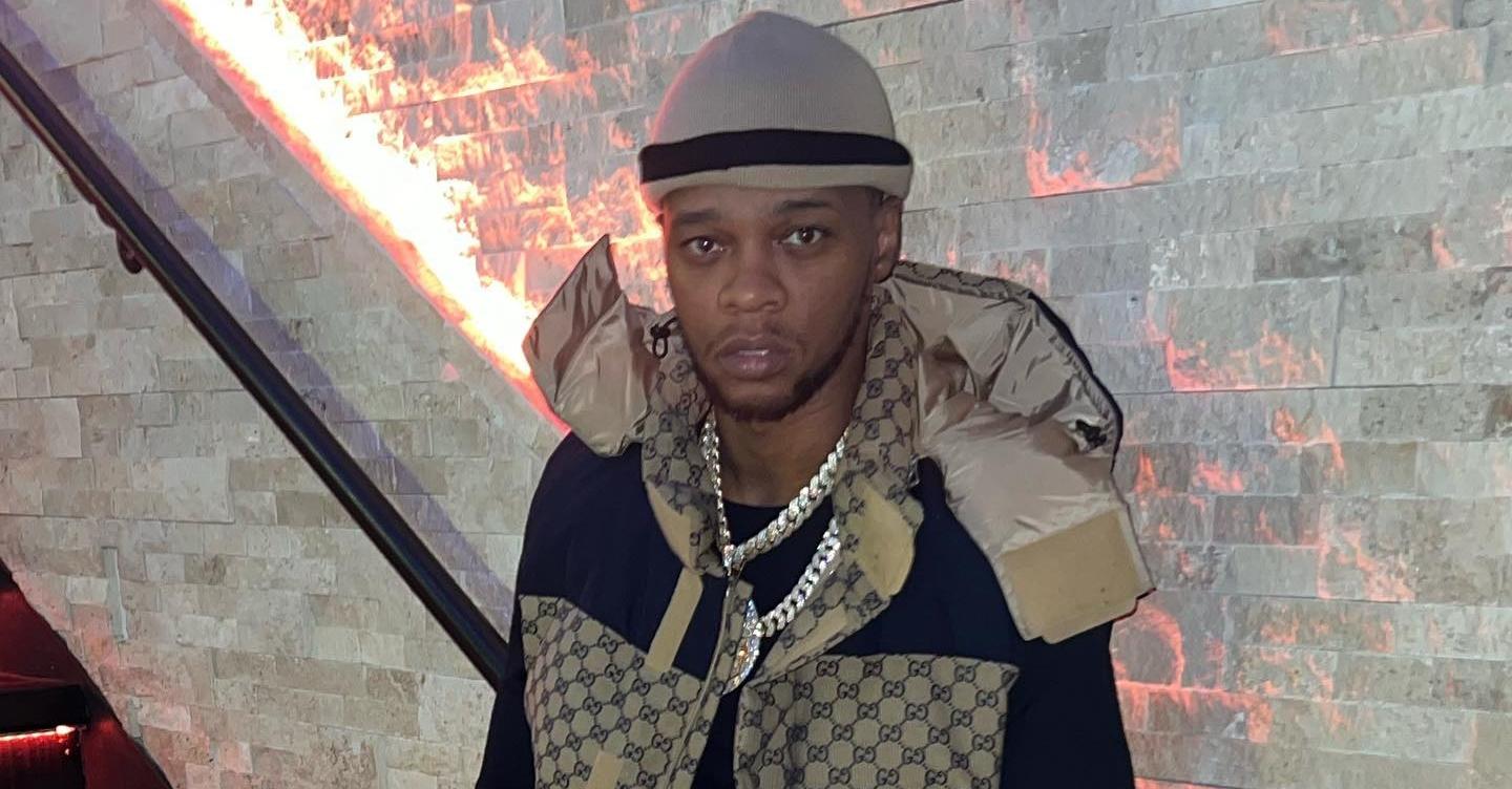 Papoose wears designer vest and diamond chain in stairwell.