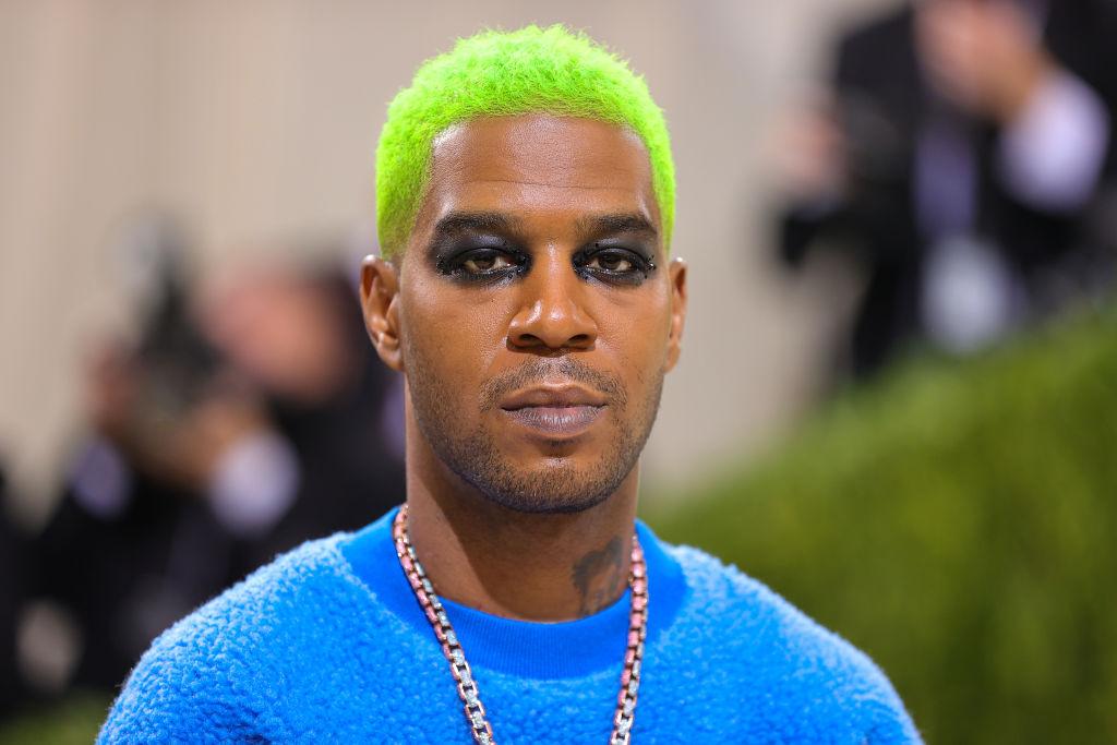 Kid Cudi with green hair, black eyeshadow, and a blue sherpa sweater at the Met Gala.