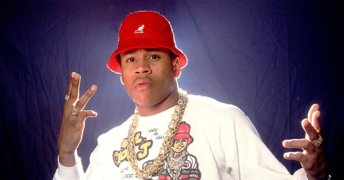 LL Cool J wearing a red Kangol hat, airbrushed t-shirt, and gold chain in a 1987 photoshoot.