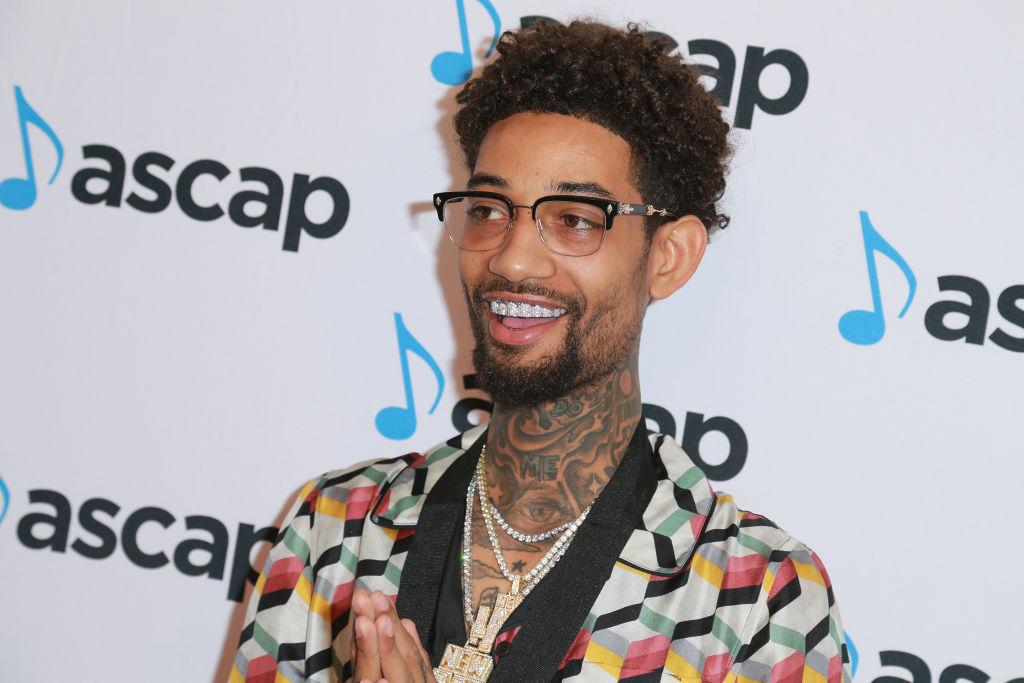 PnB Rock attends the 2018 ASCAP Rhythm & Soul Music Awards wearing glasses and diamond grills.