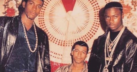 A young Terry “Southwest T” Flenory, Demetrius “Big Meech” Flenory, Derick “D-Meeks” Meeks are photographed in front of vintage tapestry.