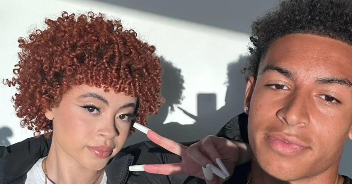 Ice Spice holds up a peace sign next to her brother Joey Gaston.