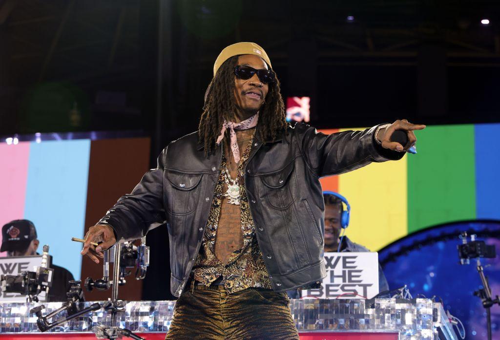 Wiz Khalifa performs onstage during the "RENAISSANCE WORLD TOUR" wearing a leather jacket and jewelry.