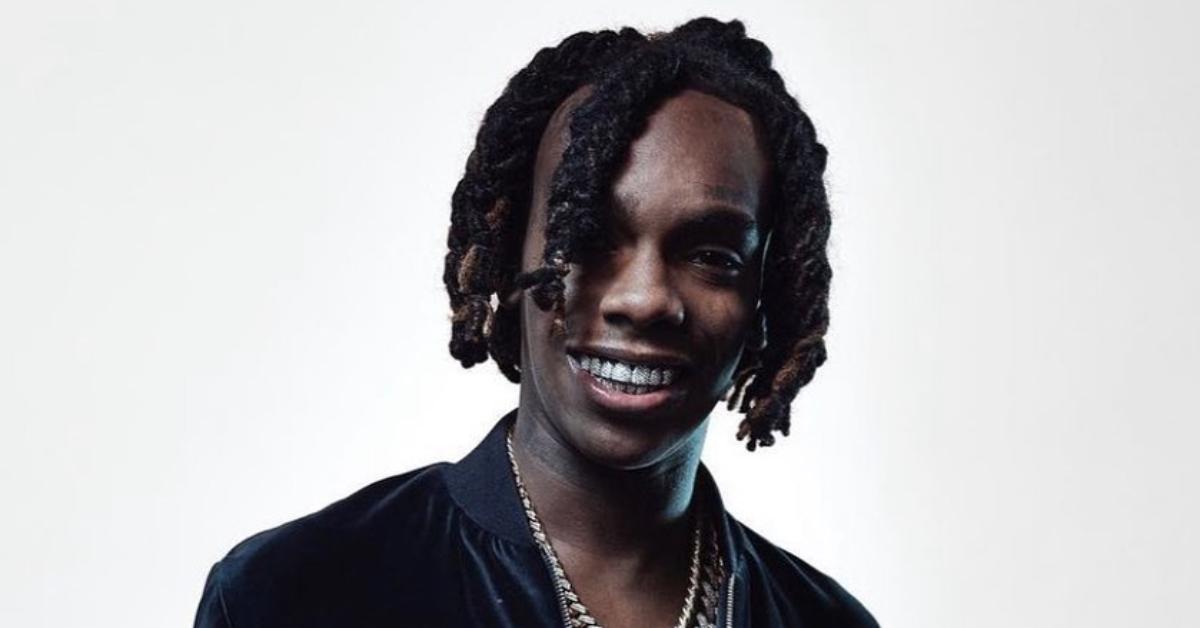 ynw melly posing in tracksuit and chains