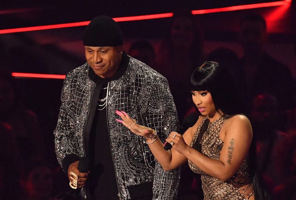 LL Cool J and Nicki Minaj speak onstage during the MTV Video Music Awards