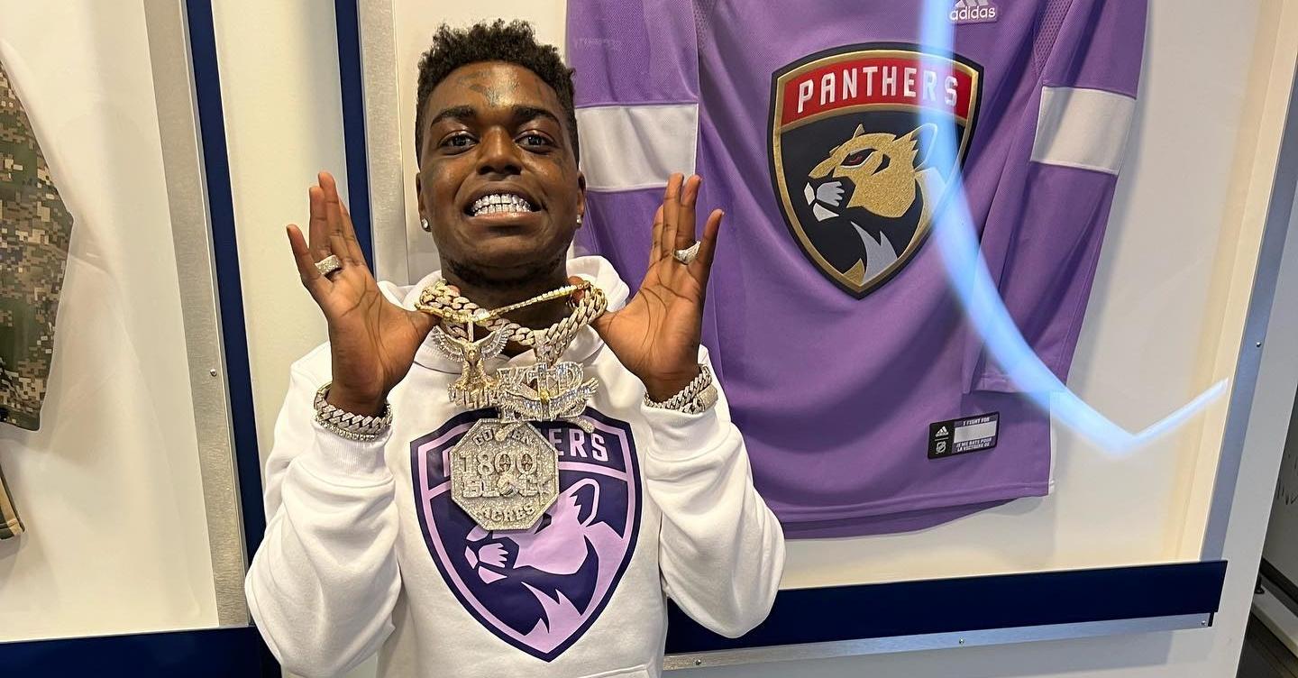 Kodak Black wears a Panthers jersey.