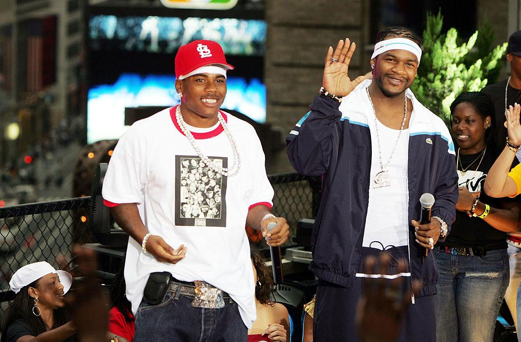 Rappers Nelly and Jaheim perform "My Place" on stage