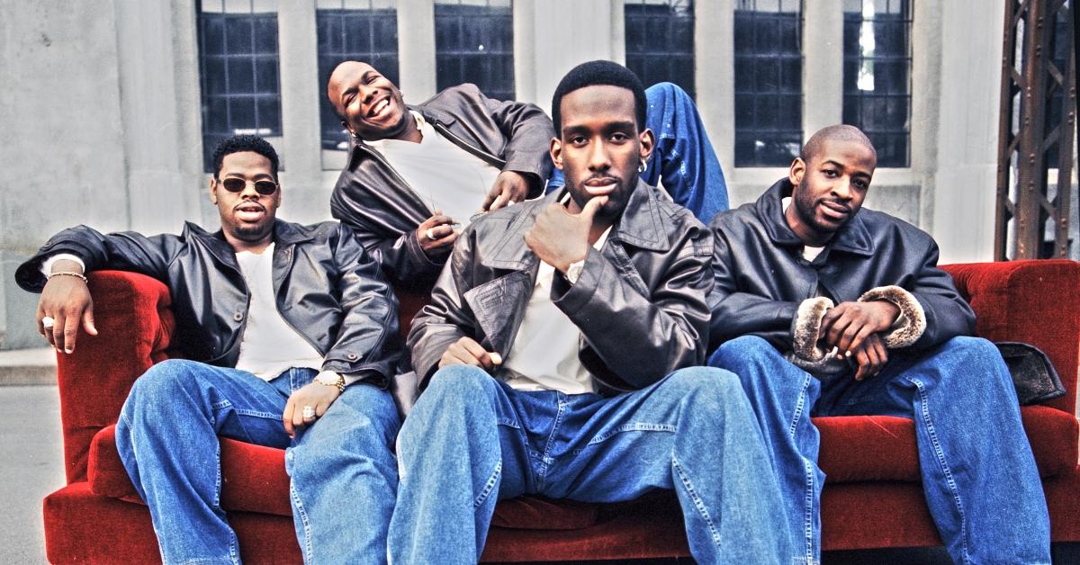 Boys II Men members sit on a red couch for a 1997 photoshoot in Los Angeles