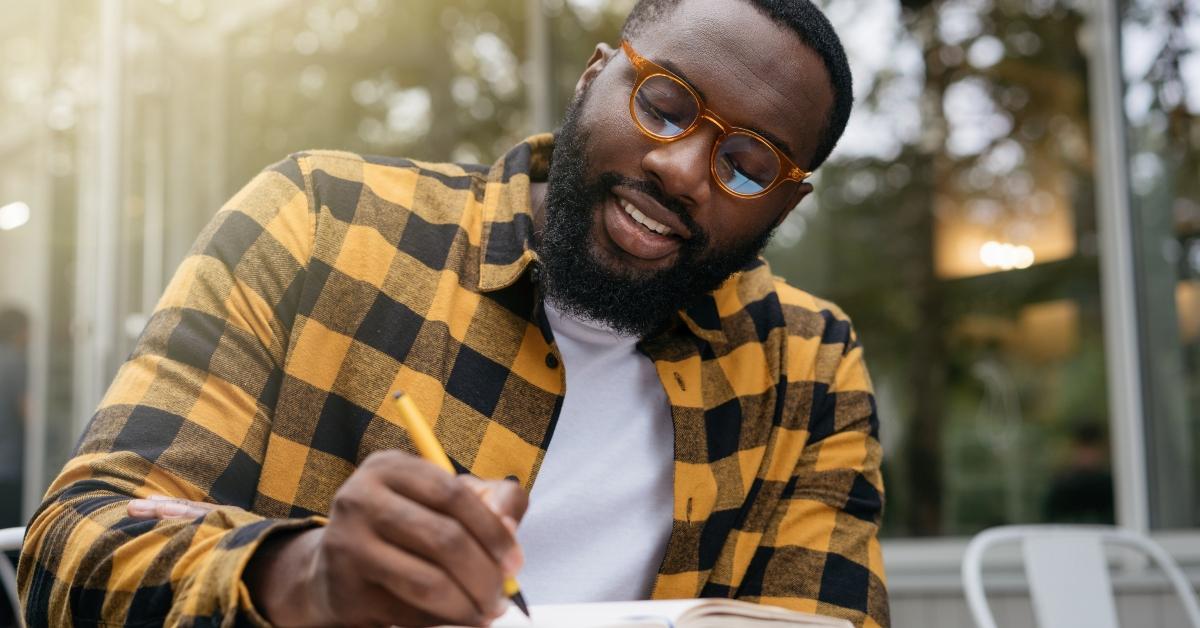 black writing in his notebook