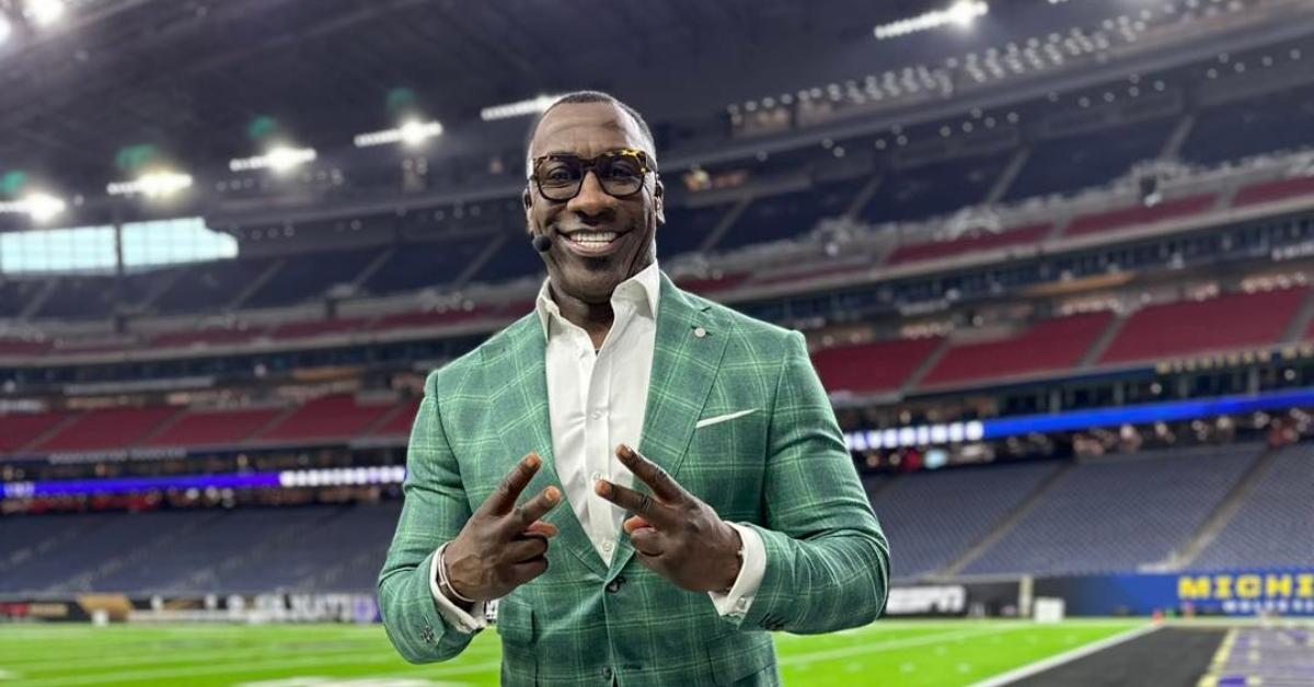 Shannon Sharpe wears a green suit.