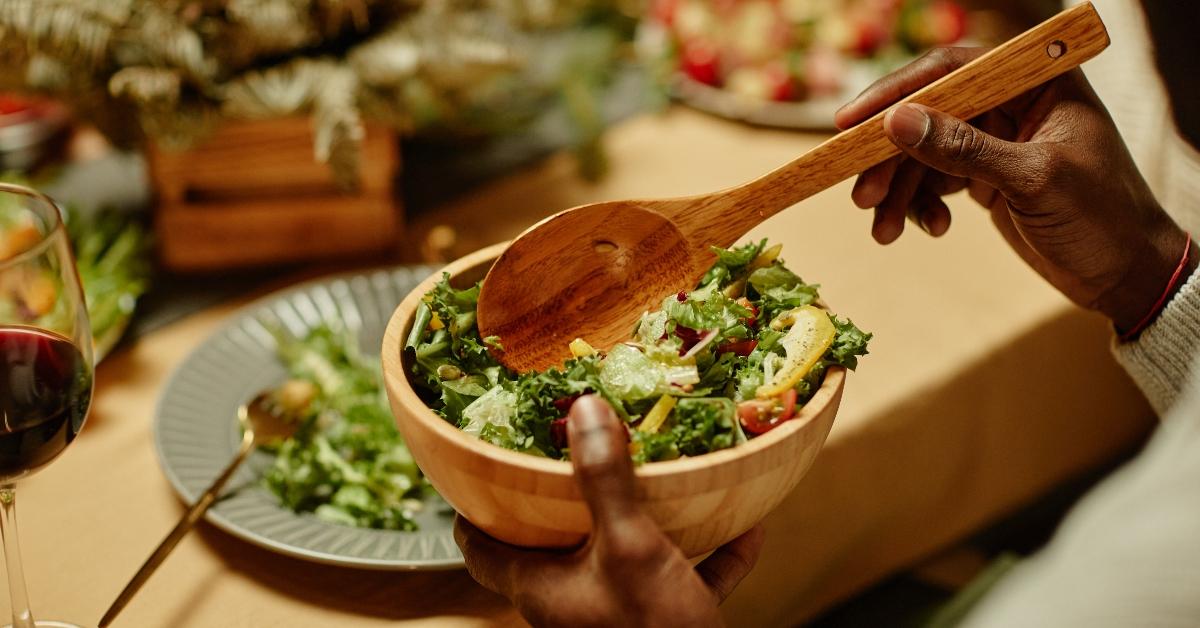 Black man serving food and enjoying dinner with his family