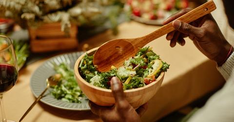 Black man serving food and enjoying dinner with his family