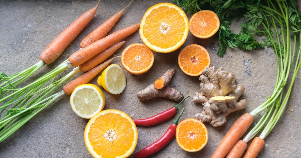 Citrus and veggies placed on a granite countertop