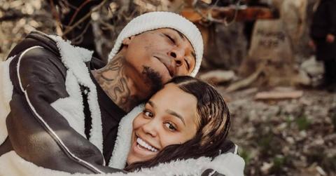 Jazlyn and NBA YoungBoy smiling for a family photo.