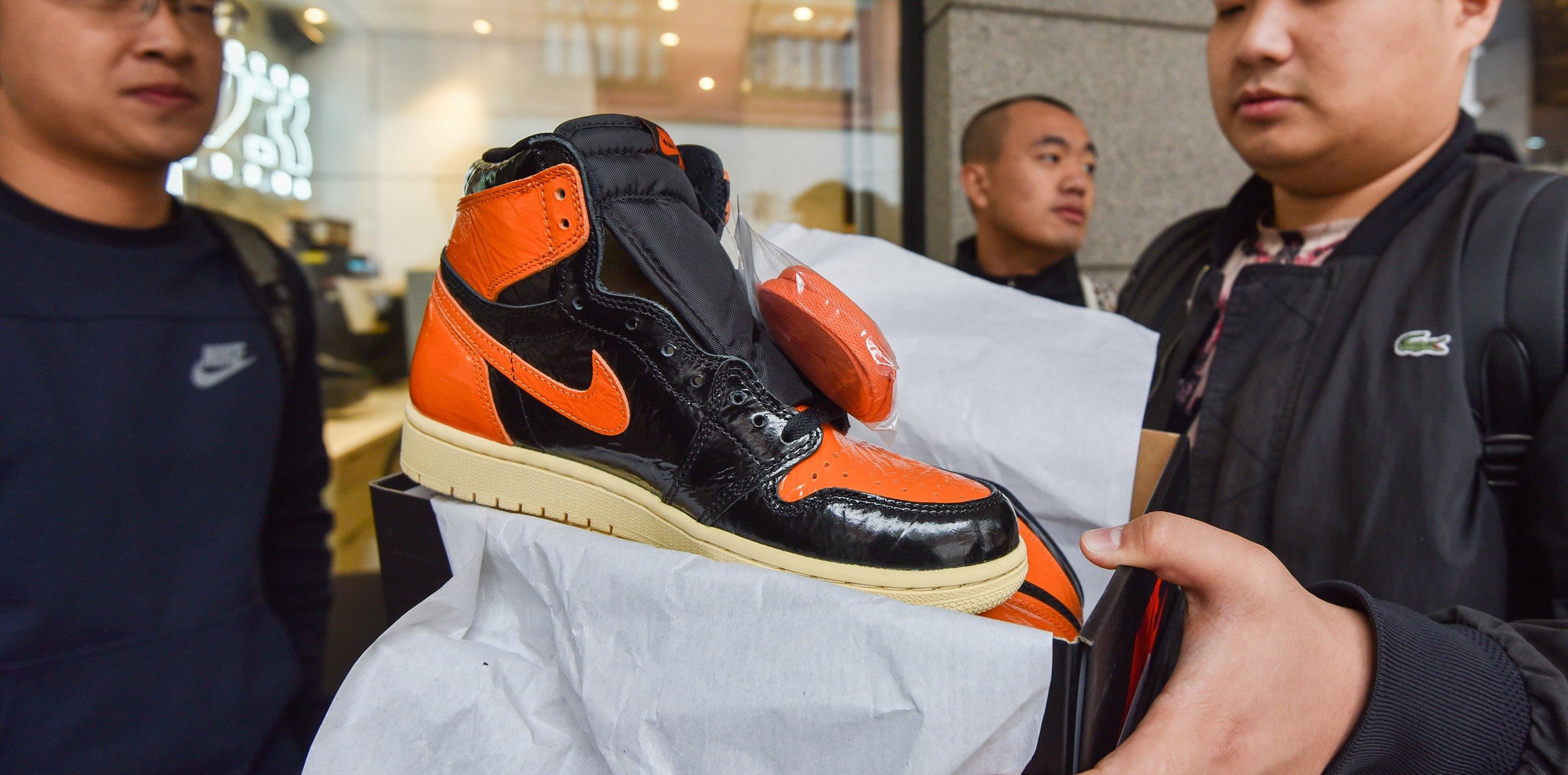 man checking a newly purchased nike sneaker