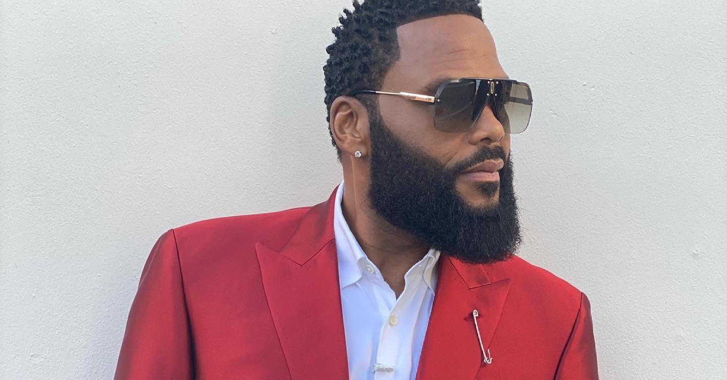 Anthony Anderson wears a red suit.