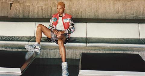 Kid Cudi sitting in MOTR merchandise with Dior Air Jordan 1s