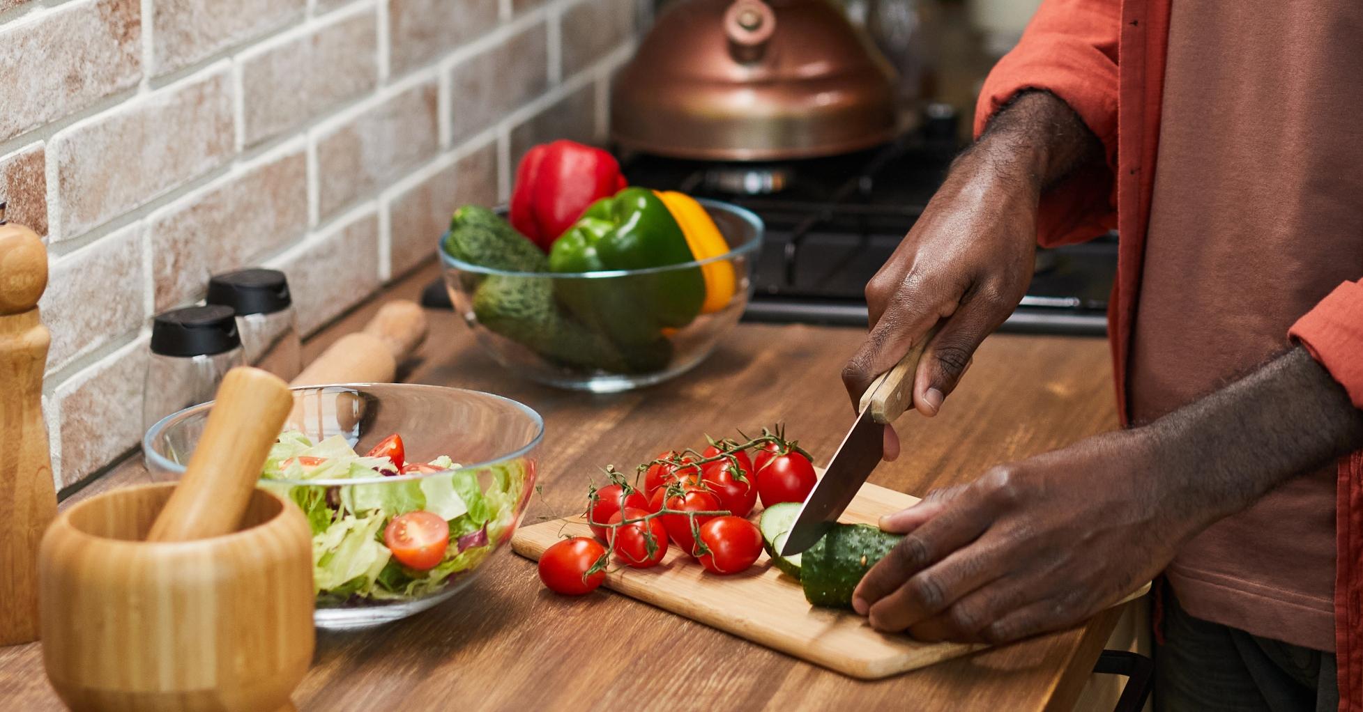 black man cutting vegetables