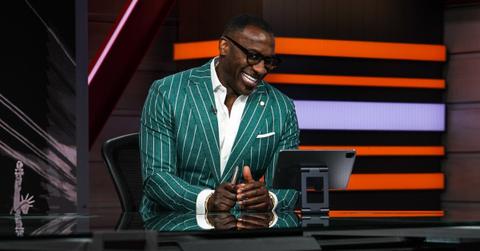 Shannon Sharpe laughing in green pinstripe suit on 'First Take'