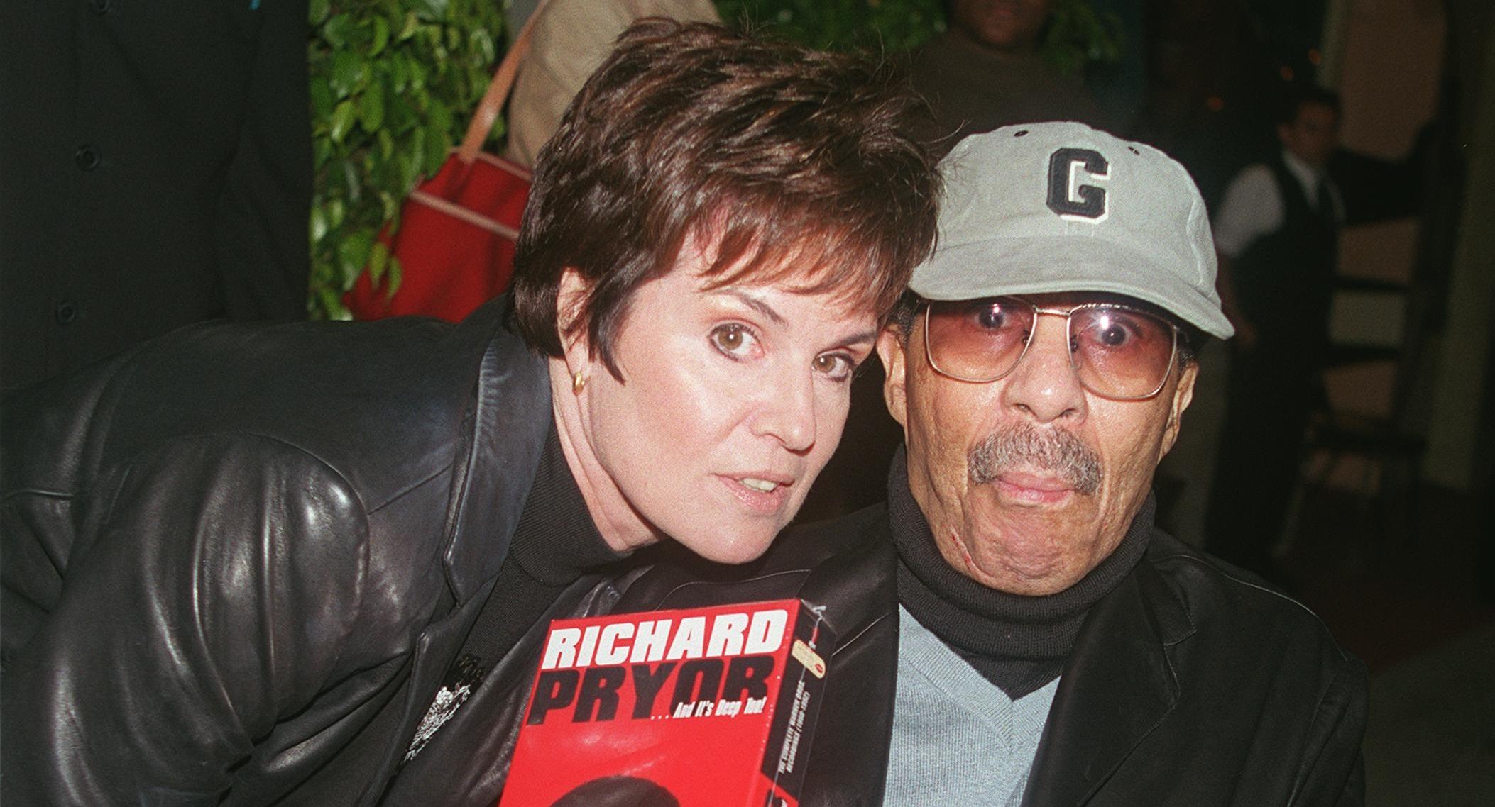 comedian richard pryor and producer jennifer lee pose for the photographer at the laugh factory