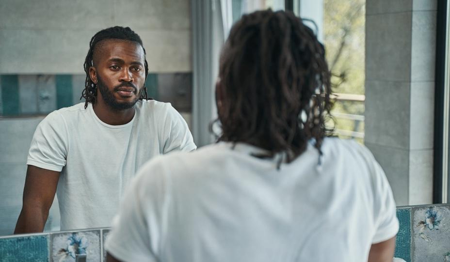 black man looking into the mirror