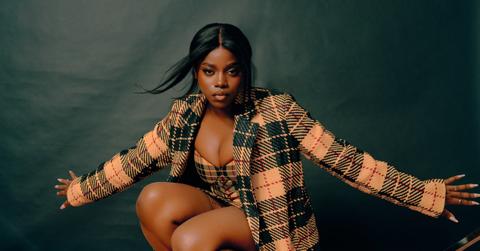 Grace Duah poses in matching plaid outfit and jacket.