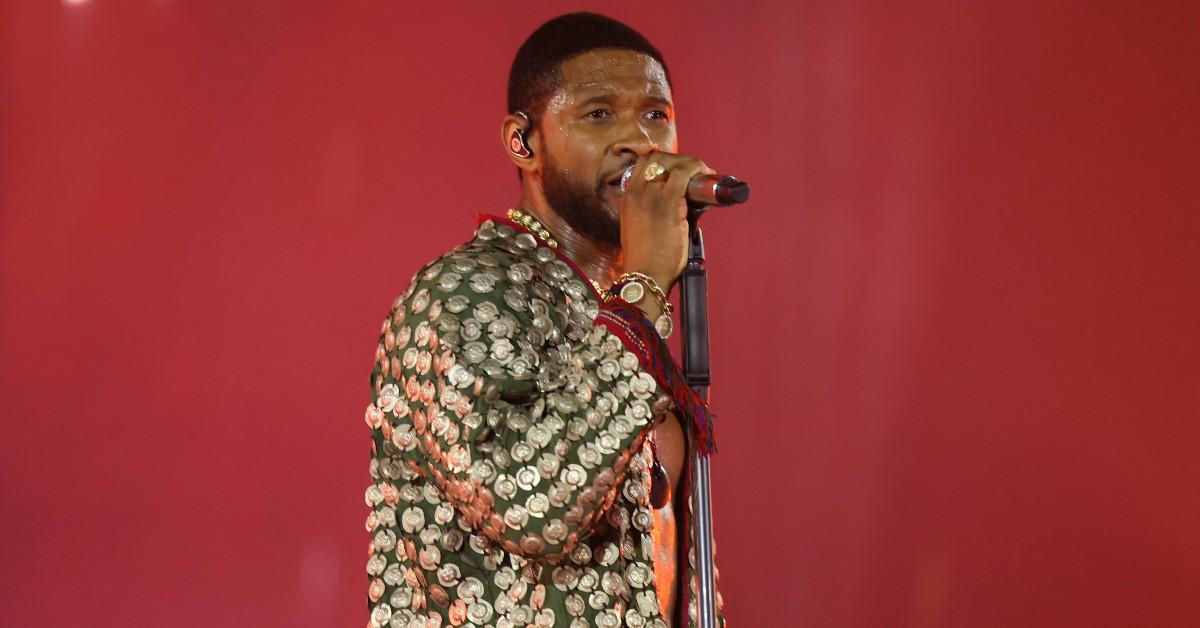 Usher sings at a concert.