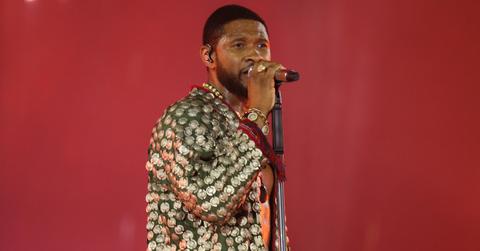 Usher sings at a concert.