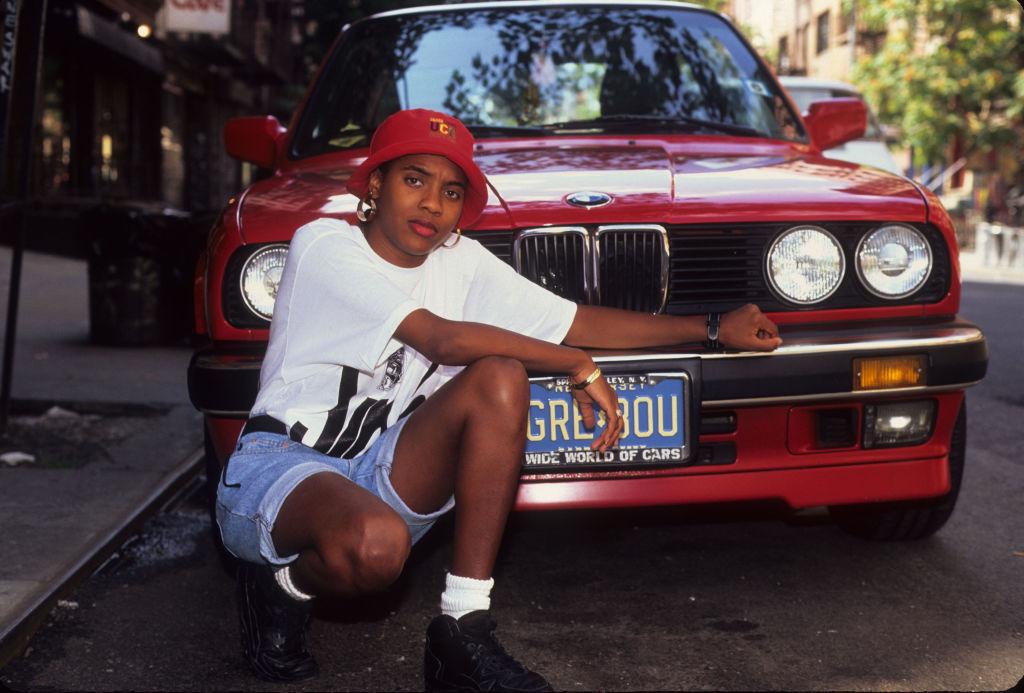 rapper mc lyter poses in front of bmw