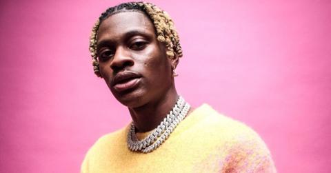 PsychoYP wearing a pink and yellow sweater.