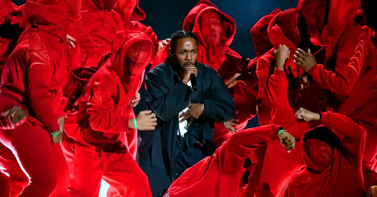 : Recording artist Kendrick Lamar performs onstage during the 60th Annual GRAMMY Awards at Madison Square Garden surrounded by men in red masks and suits.