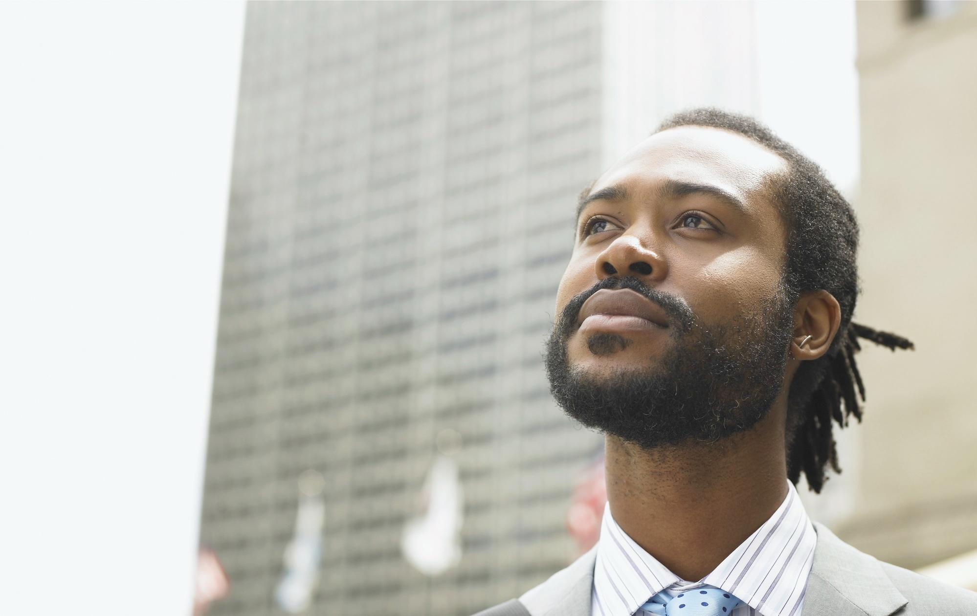 A Black man looking into the distance.