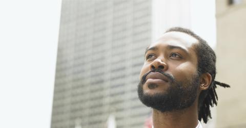 A Black man looking into the distance.